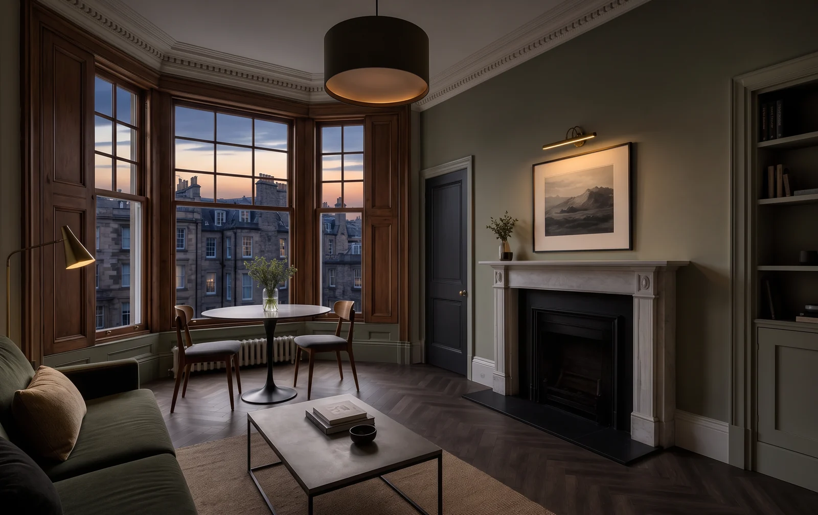Refurbished Edinburgh tenement living room with bay sash window, cornicing and fireplace at dusk, ready for re-letting